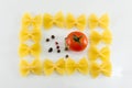 Farfalle pasta forming shapes on white