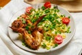 Farfalle pasta with grilled chicken wings garnished with cherry tomatoes and green onions Royalty Free Stock Photo