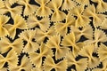 Farfalle pasta pattern on black background, top view, flat lay texture Royalty Free Stock Photo