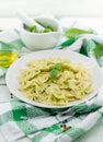 Farfalle pasta with pesto genovese basil sauce on white rusti Royalty Free Stock Photo