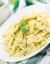 Farfalle pasta with pesto genovese & x28;basil sauce& x29; on rustic wood Royalty Free Stock Photo