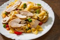 Farfalle pasta salad with chicken breast fillet and vegetables in plate Royalty Free Stock Photo