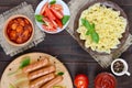 Farfalle pasta, sausages on skewers, fresh tomatoes, spicy tomato sauce