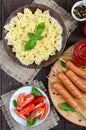 Farfalle pasta, sausages on skewers, fresh tomatoes, spicy tomato sauce.