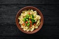 Farfalle pasta with vegetables on the plate. Royalty Free Stock Photo