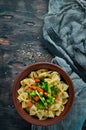 Farfalle pasta with vegetables on the plate. Royalty Free Stock Photo