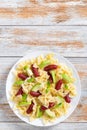 Farfalle Pasta warm salad with avocado slices and basil Royalty Free Stock Photo