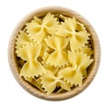 Farfalle pasta in wooden bowl. Uncooked dried durum wheat