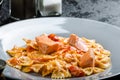 Farfalle with tomato sauce and roasted salmon Royalty Free Stock Photo