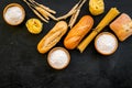 Farinaceous food. Fresh bread and raw pasta near flour in bowl and wheat ears on black background top view space for