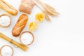 Farinaceous food. Fresh bread and raw pasta near flour in bowl and wheat ears on white background top view space for
