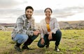 Farm, agriculture and portrait of happy couple on grass field kneeling together for teamwork. Diversity, sustainability Royalty Free Stock Photo