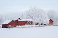 Farm barn and house surrounded by frosty trees Royalty Free Stock Photo