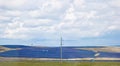 A farm of batteries of solar power plants on a field under a sky full of clouds. green electricity. alternative energy Royalty Free Stock Photo