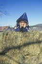 Farm boy on hay bales Royalty Free Stock Photo