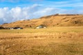 Farm Buildings at the Foot of Hill and Blue Sky Royalty Free Stock Photo