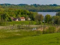 A farm in the countryside with a lake in the background