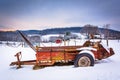 Farm equipment in a snow covered field in rural Carroll County,