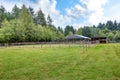 Farm field with empty horse barn Royalty Free Stock Photo