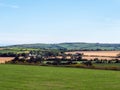 farm fields and hills in the evening in Ireland. Irish rural landscape, agricultural land. Green grass field near green trees Royalty Free Stock Photo