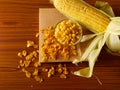 Fresh corn, a bowl of corn kernels and flattened toasted cornflakes Royalty Free Stock Photo