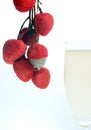 Farm fresh litchi fruits with cool juice in a glass