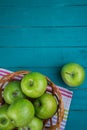 Farm fresh organic green apples in basket on wooden retro blue Royalty Free Stock Photo