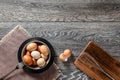 Farm fresh organic large brown and white eggs in bowl on rustic dark oak wood background table. Royalty Free Stock Photo