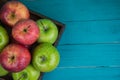 Farm fresh organic red and green apples on wooden table in paste Royalty Free Stock Photo