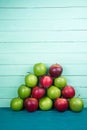 Farm fresh pyramid of organic red and green autumn apples on woo Royalty Free Stock Photo