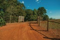 Farm gate with cattle guard and barbed wire fence Royalty Free Stock Photo