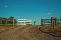 Farm gate with cattle guard and barbed wire fence Royalty Free Stock Photo