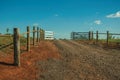 Farm gate with cattle guard and barbed wire fence Royalty Free Stock Photo