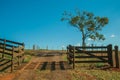 Farm gate with cattle guard and barbed wire fence Royalty Free Stock Photo