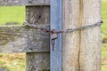 A farm gate locked with a chain and padlock Royalty Free Stock Photo