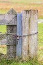 A farm gate locked with a chain and padlock Royalty Free Stock Photo