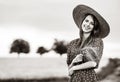 Farm girl holding wheat ears on a field Royalty Free Stock Photo