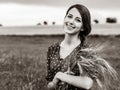 Farm girl holding wheat ears on a field Royalty Free Stock Photo