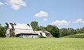 Farm House in a field of Green Grass Royalty Free Stock Photo