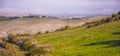 A farm house sits at the top of the hill under the fog in Tuscany Royalty Free Stock Photo