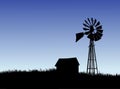 Farm house and windmill silhouette Royalty Free Stock Photo
