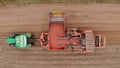 Farm machinery harvesting potatoes. Farmer field with a potato crop. Royalty Free Stock Photo