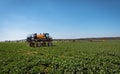 Farm machinery spraying insecticide.