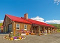Farm Market With Stone Chimney Building Serving Foods, Produce And Flowers In Fall