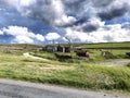 Farm with outbuildings, and machinery, on the moor top above, Wycoller, Lancashire, UK