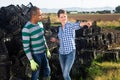 Farm owner gives instructions to the hired worker on the field