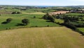 farm plots, top view. Irish agrarian landscape. Green fields on a sunny summer day. Green grass field under blue sky