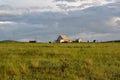 Farm and residential wooden houses on a green meadow