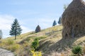 Haystacks on a hill near the dirt road Royalty Free Stock Photo