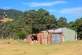 Farm sheds, one old and crumbling, in a rural landscape. New Zealand Royalty Free Stock Photo